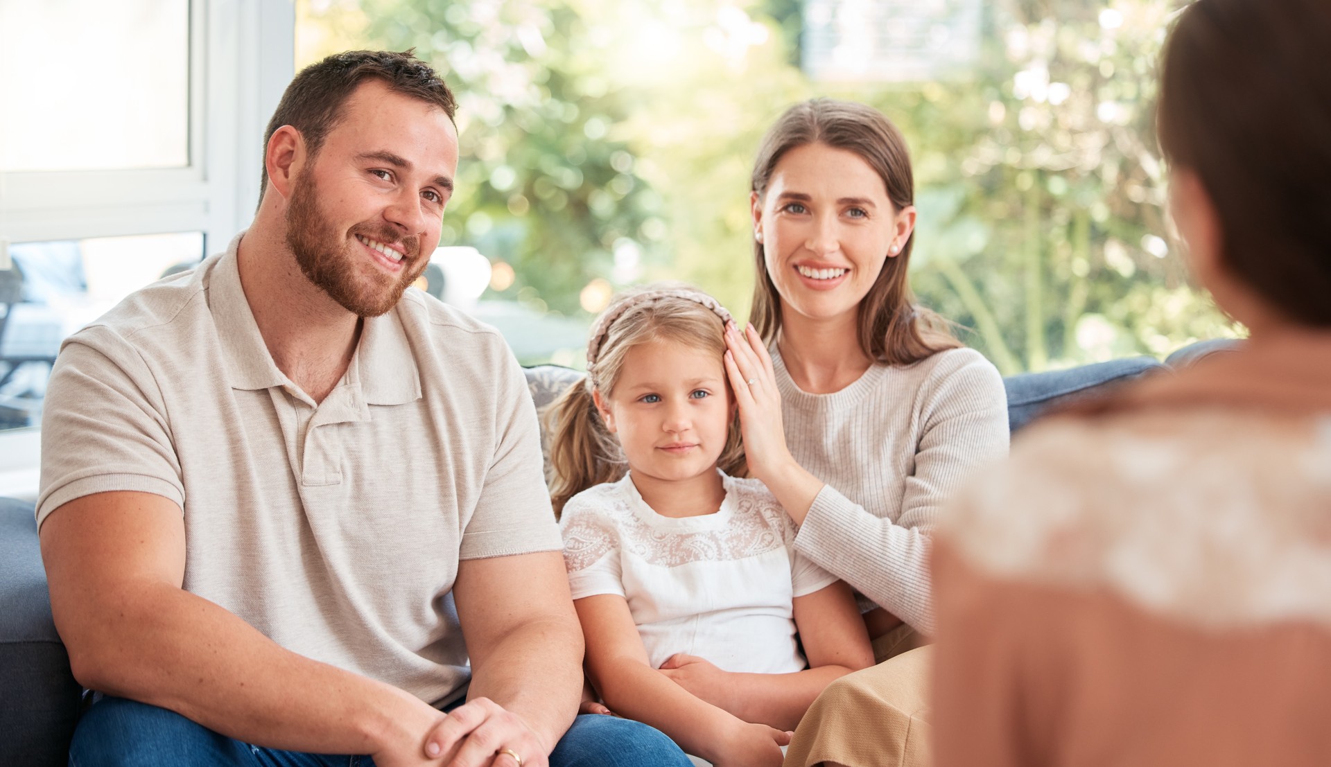 Shot of a young family having a discussion with someone at home